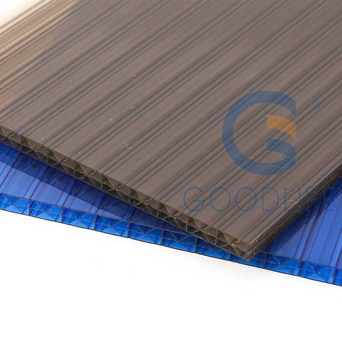 Stacked blue and tea-color X-structure polycarbonate sheets showcasing available color options and light transmission properties